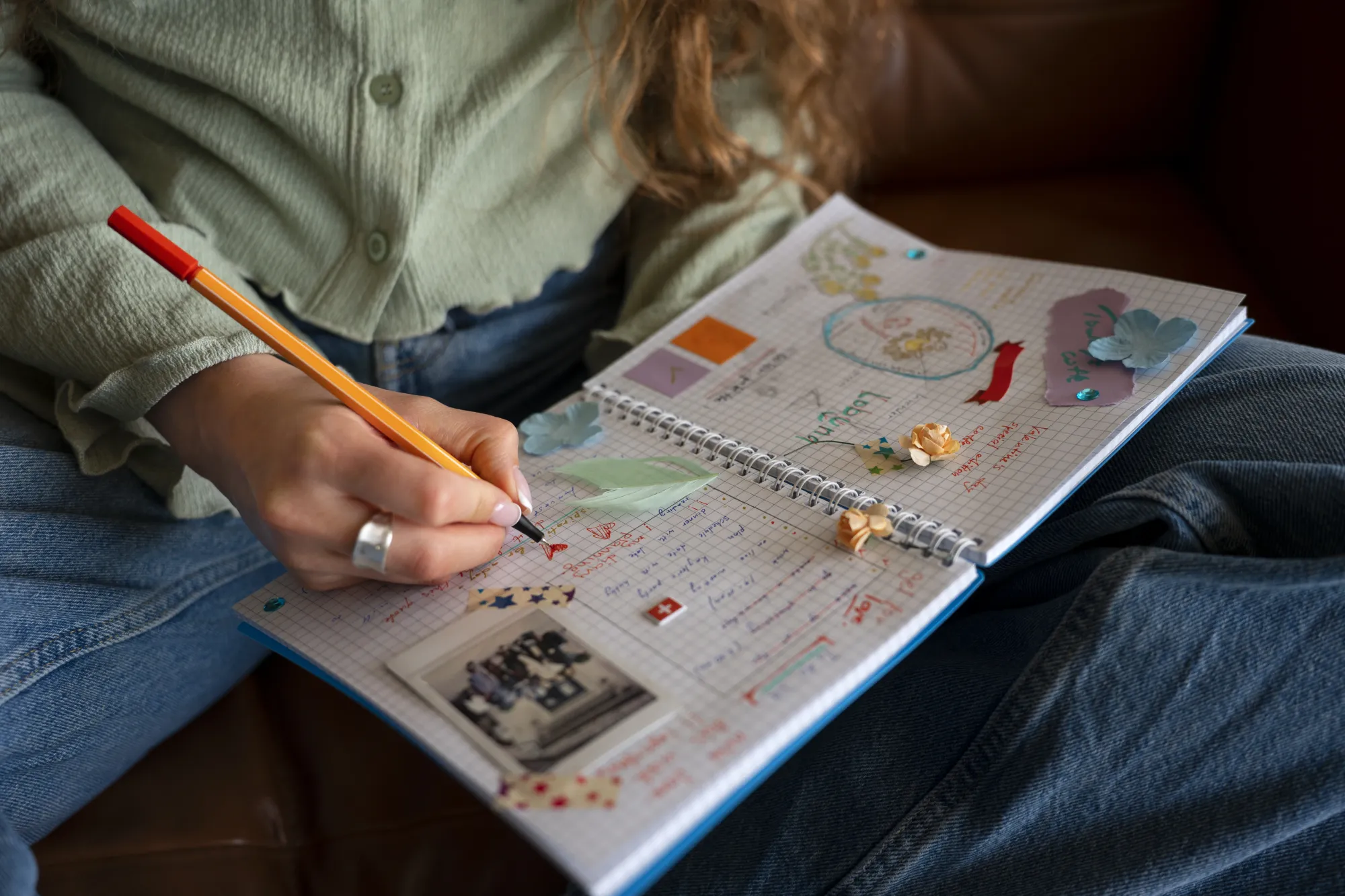 A girl using paper journal for creativity and sketching