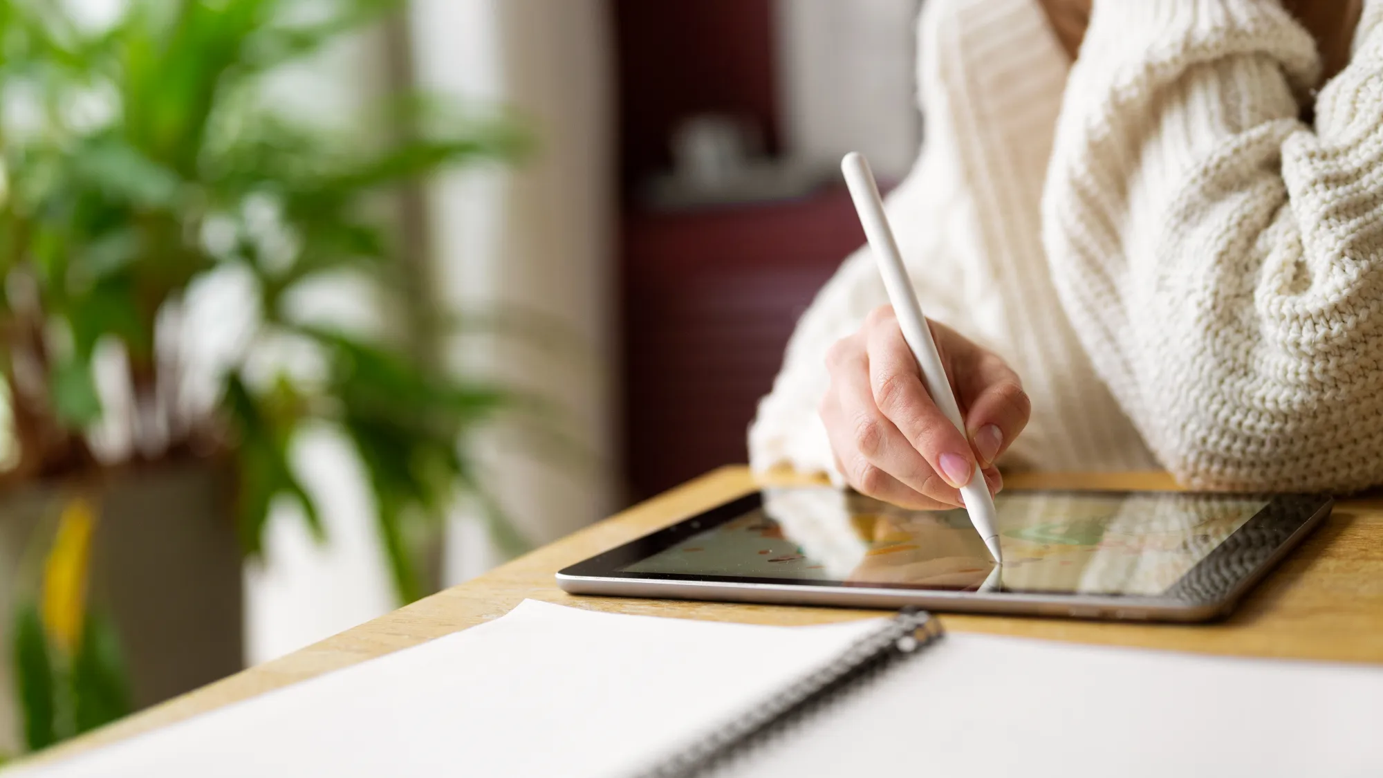 A girl using digital pen for journaling in a tab