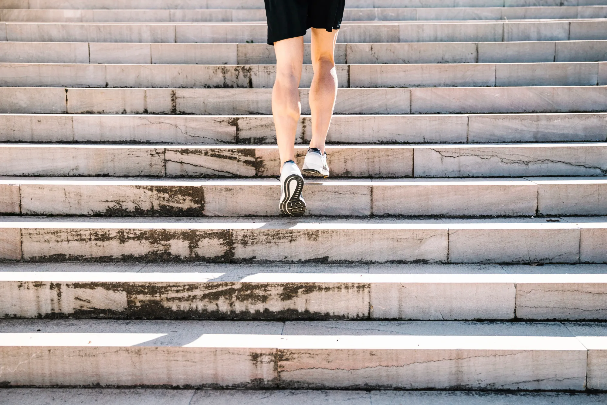 A man climbing up the stairs to avail the benefits of cardio