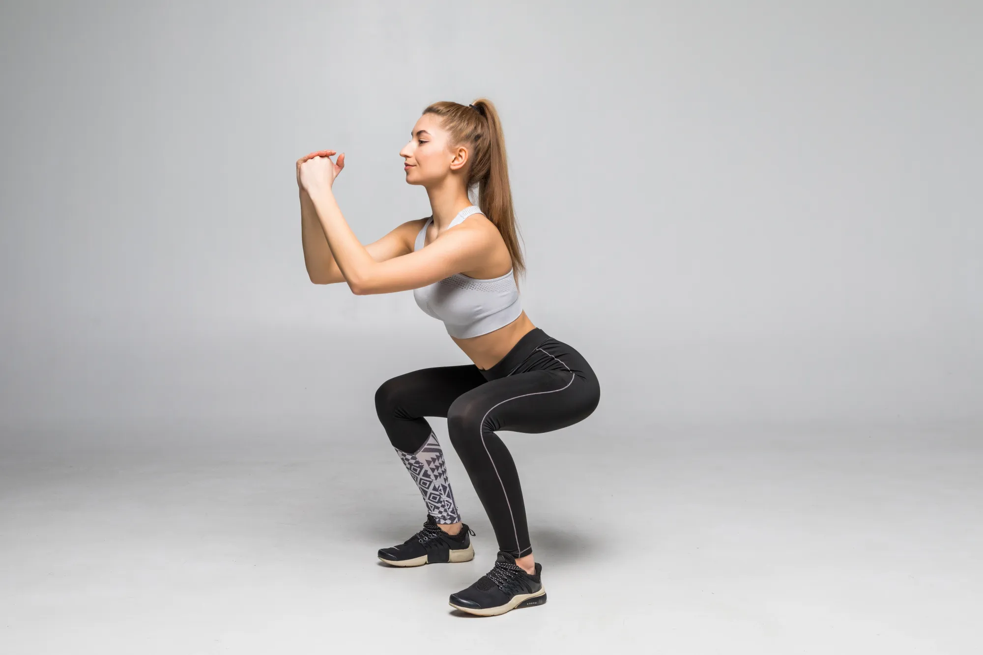 Woman doing squats to attain a slim figure