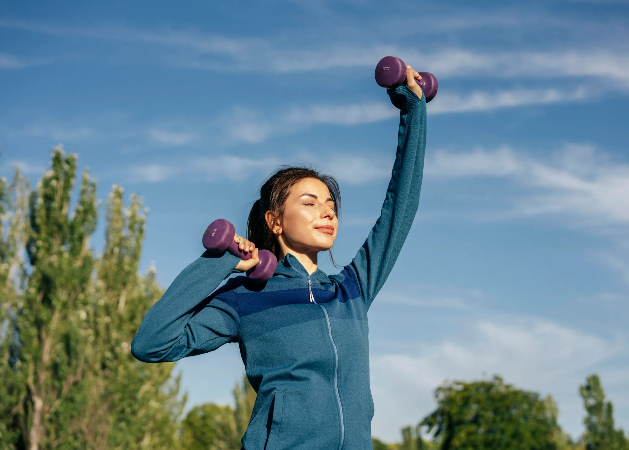 Woman doing exercise with dumbells to find out why should we meditate and exercise regularly