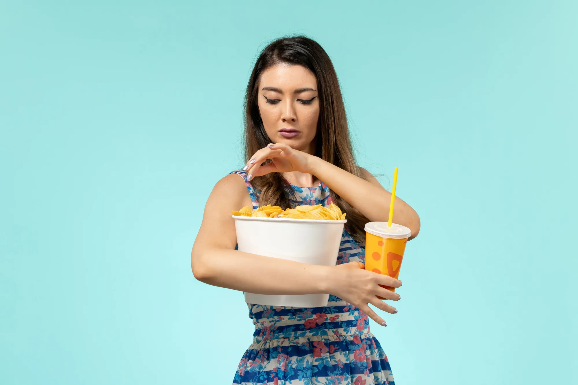 A girl eating processed food which can cause lifestyle diseases, often discussed in health talks