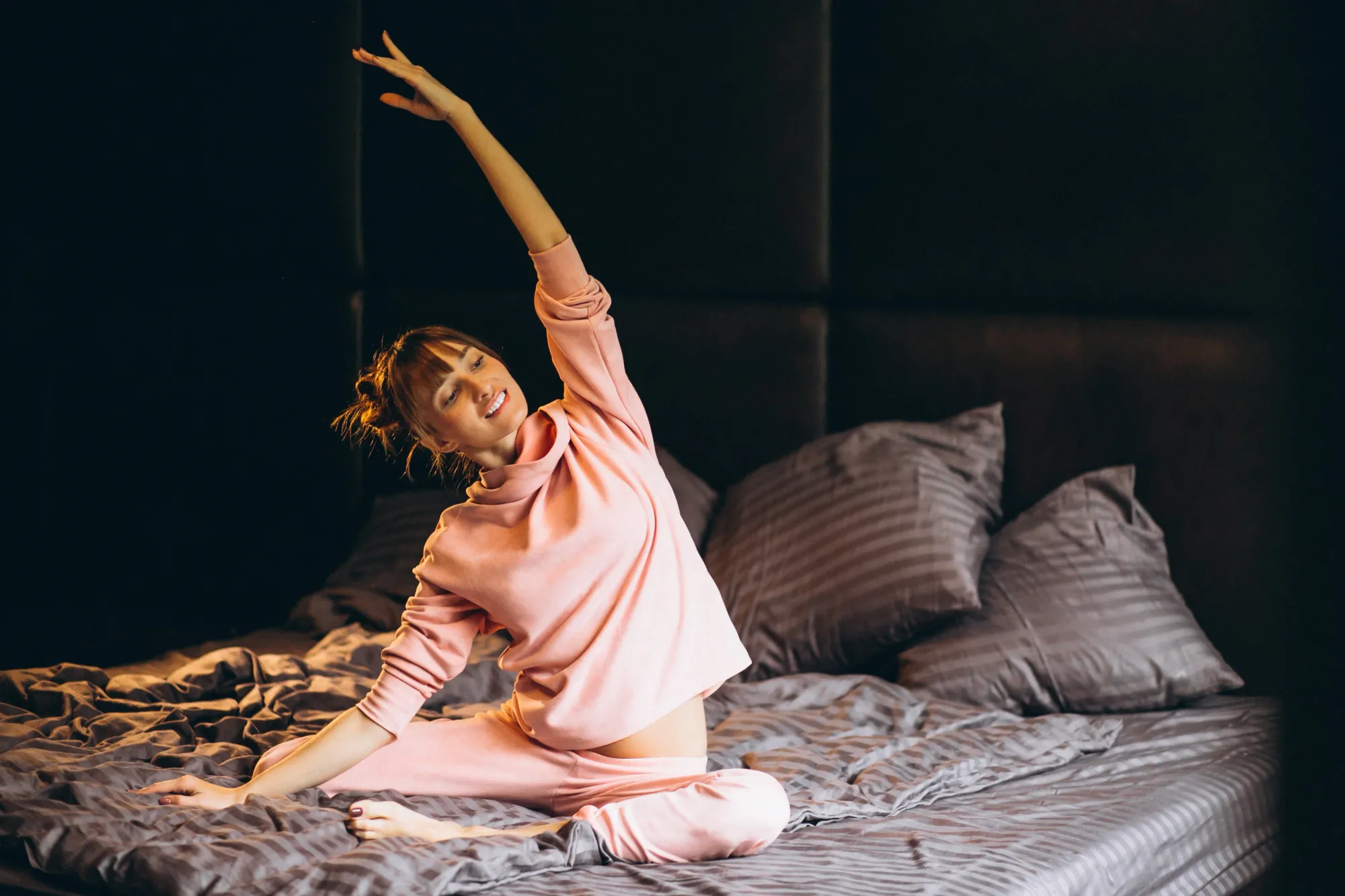 A woman doing relaxing stretches to prevent hypnic jerk or sleep starts from happening