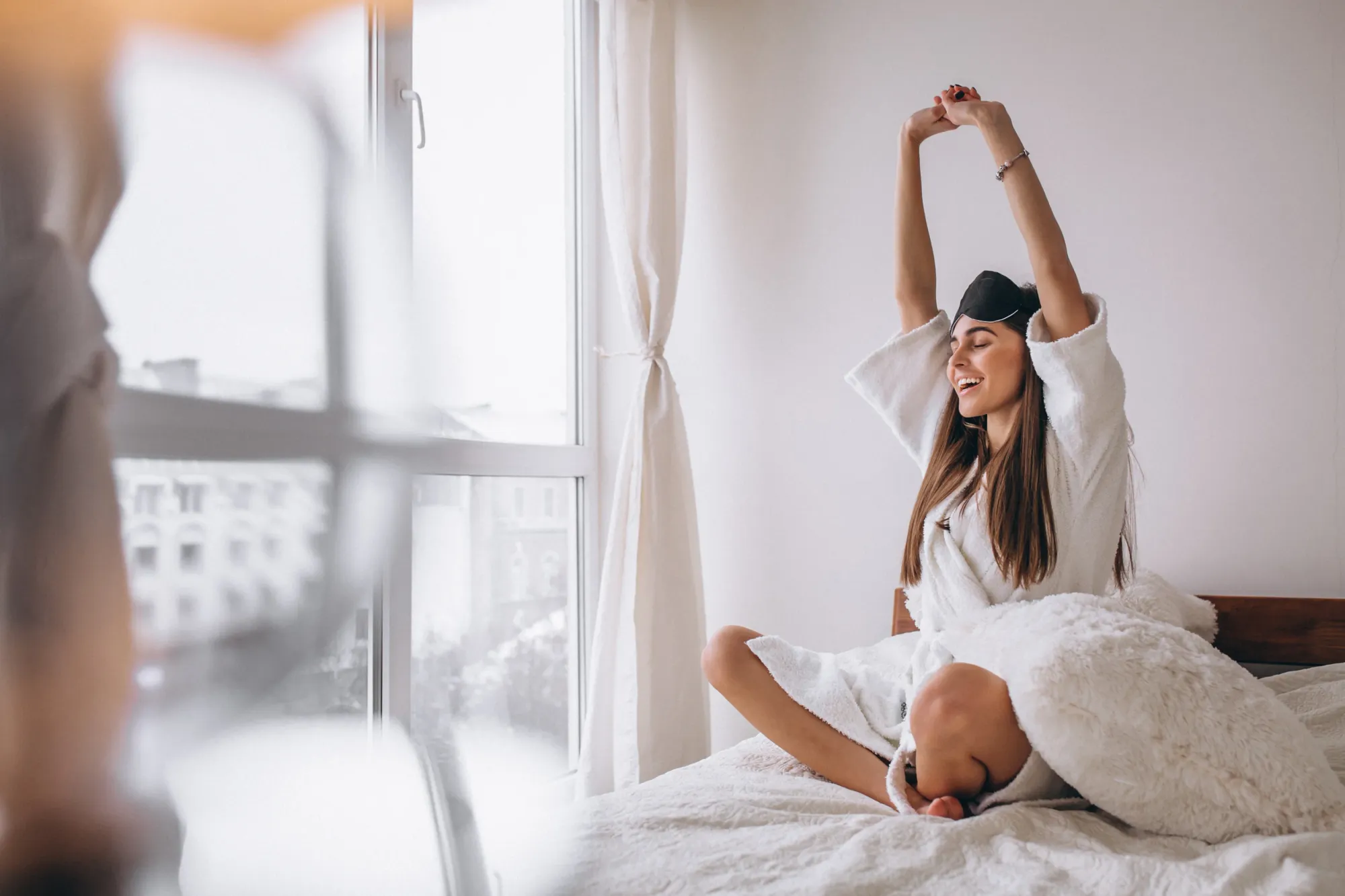 A woman waking up feeling refreshed after having required hours of core sleep
