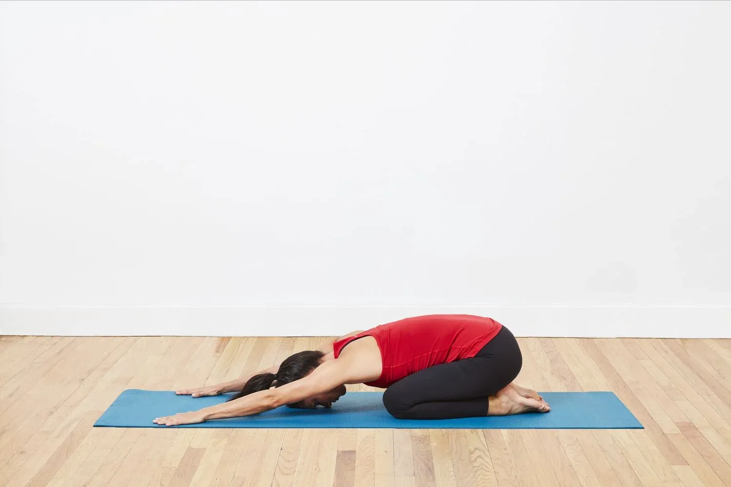 A woman doing child's pose, a lying down yoga asana for better sleep