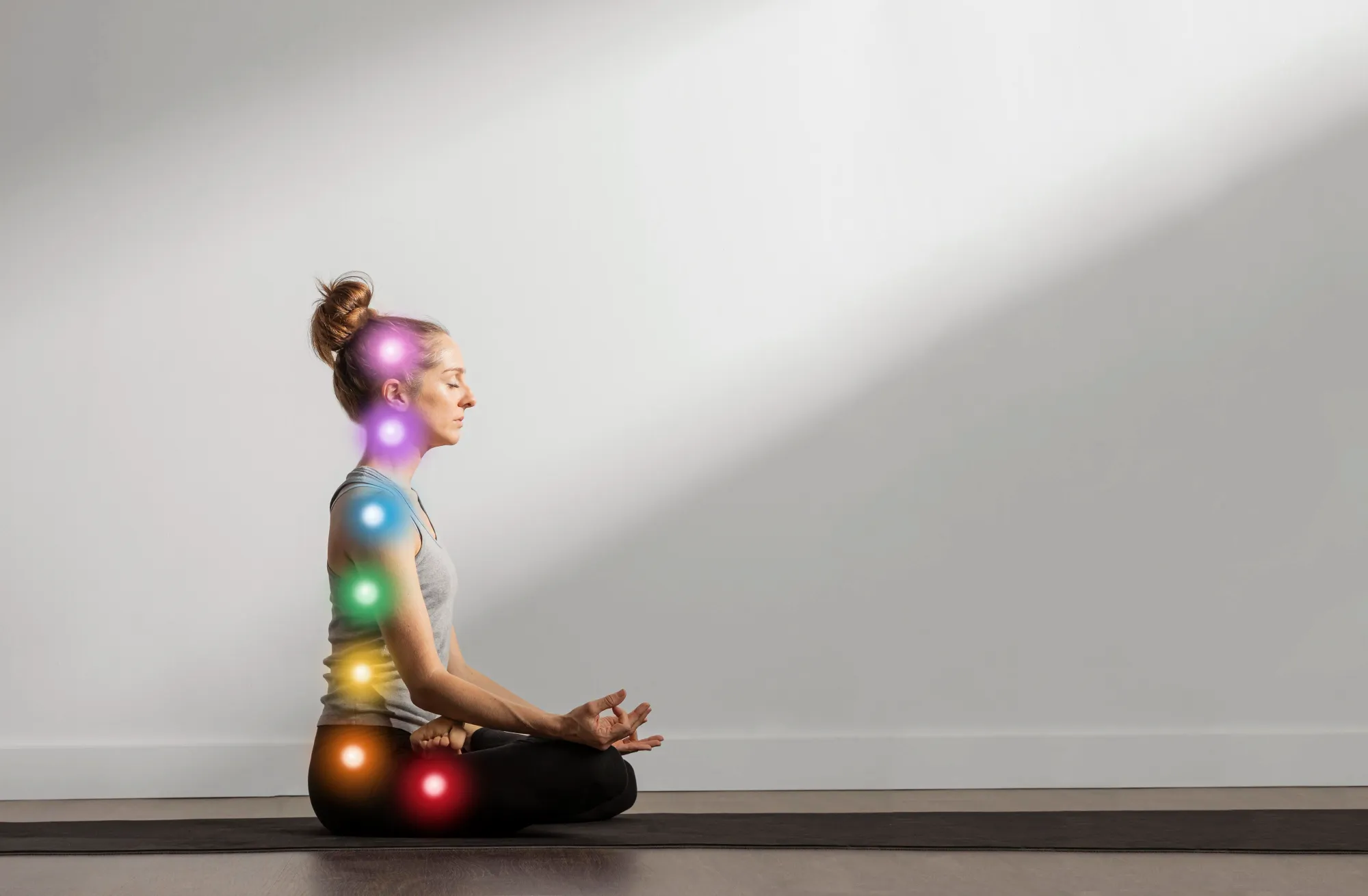 A woman doing chakra meditation, a type of meditation to cleanse the energy centers in the body