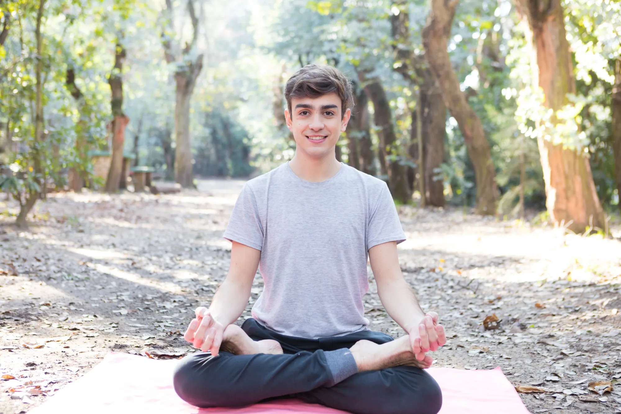 A young man benefitting from meditation for students with better focus and sleep.