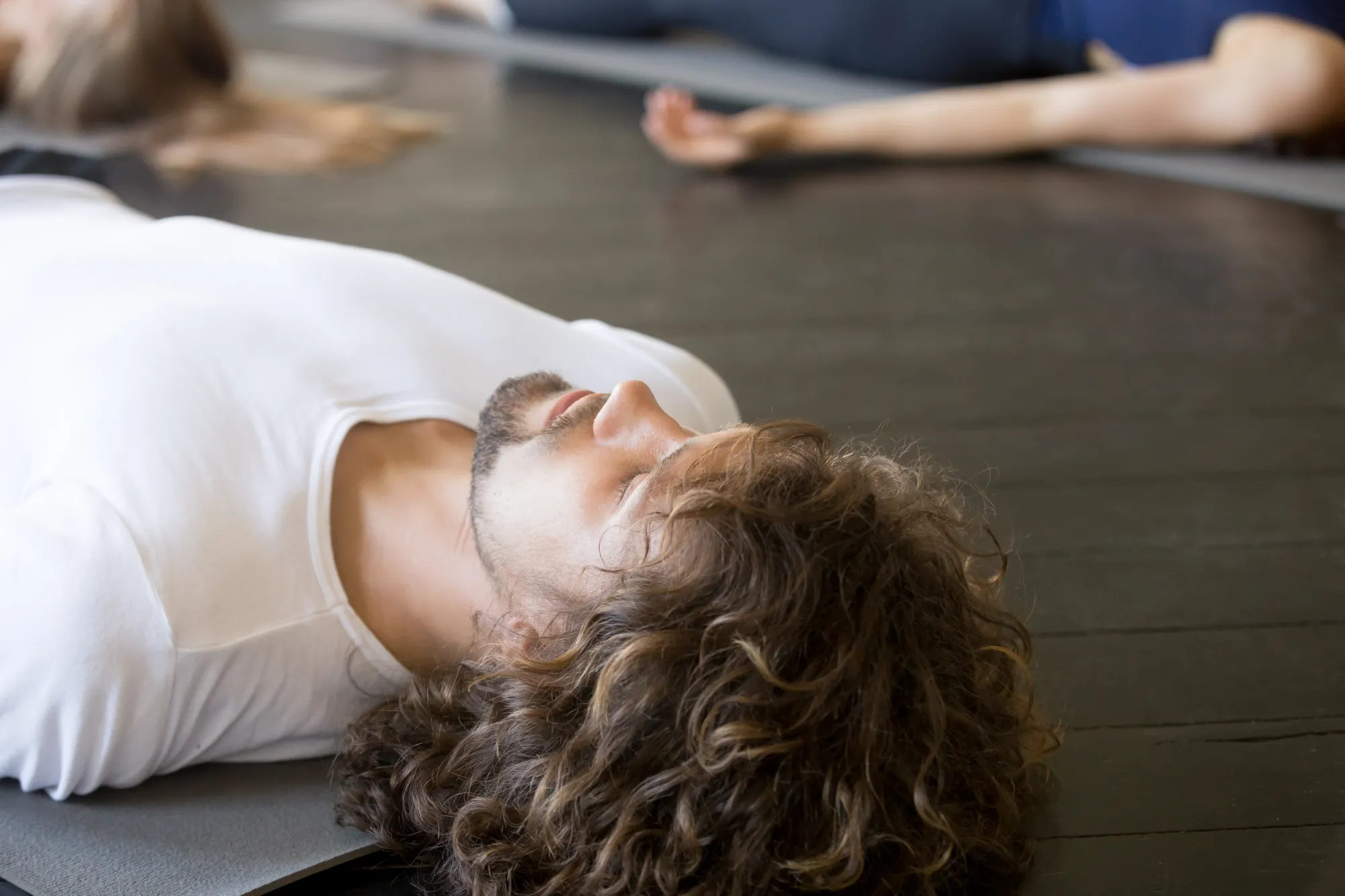 A man doing yog nidra for sleep, in a group session