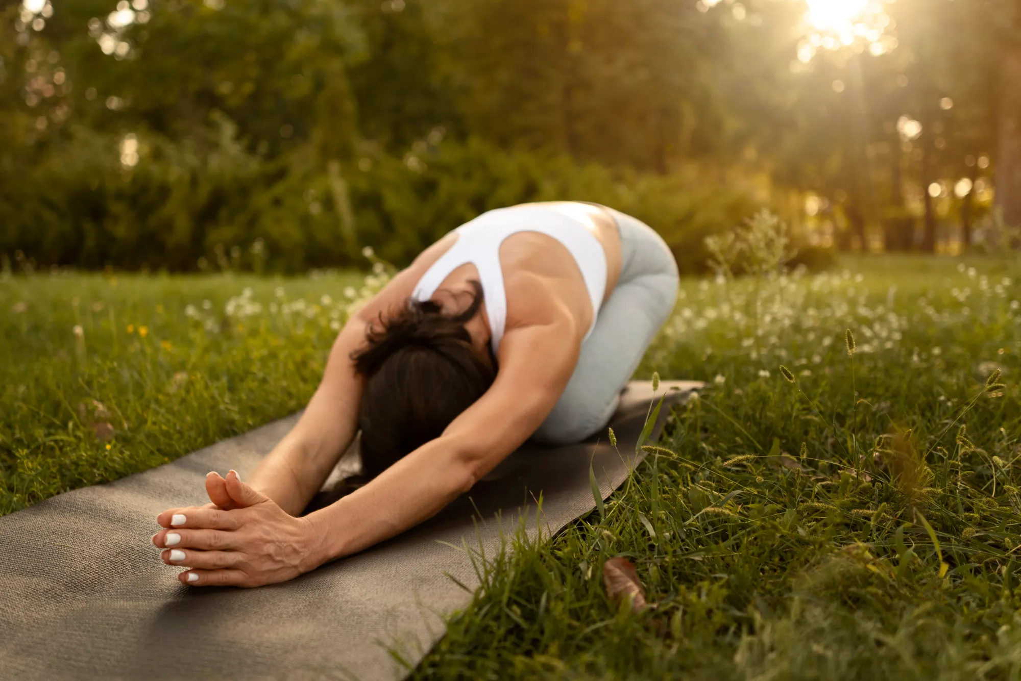 A woman doing sun salutation to experience its benefits