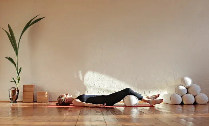 A woman doing yoga nidra, a combination of yoga and meditation