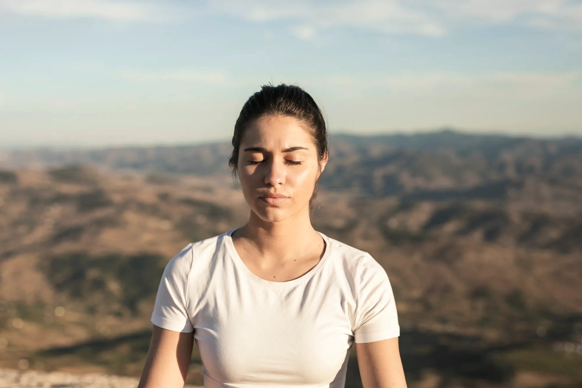 A woman meditating to heal herself mentally after breakup