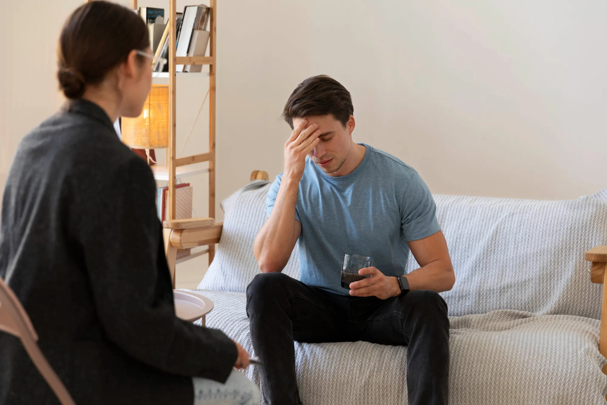 A man in depressed mood talking to a therapist to fix a breakup heart and move on