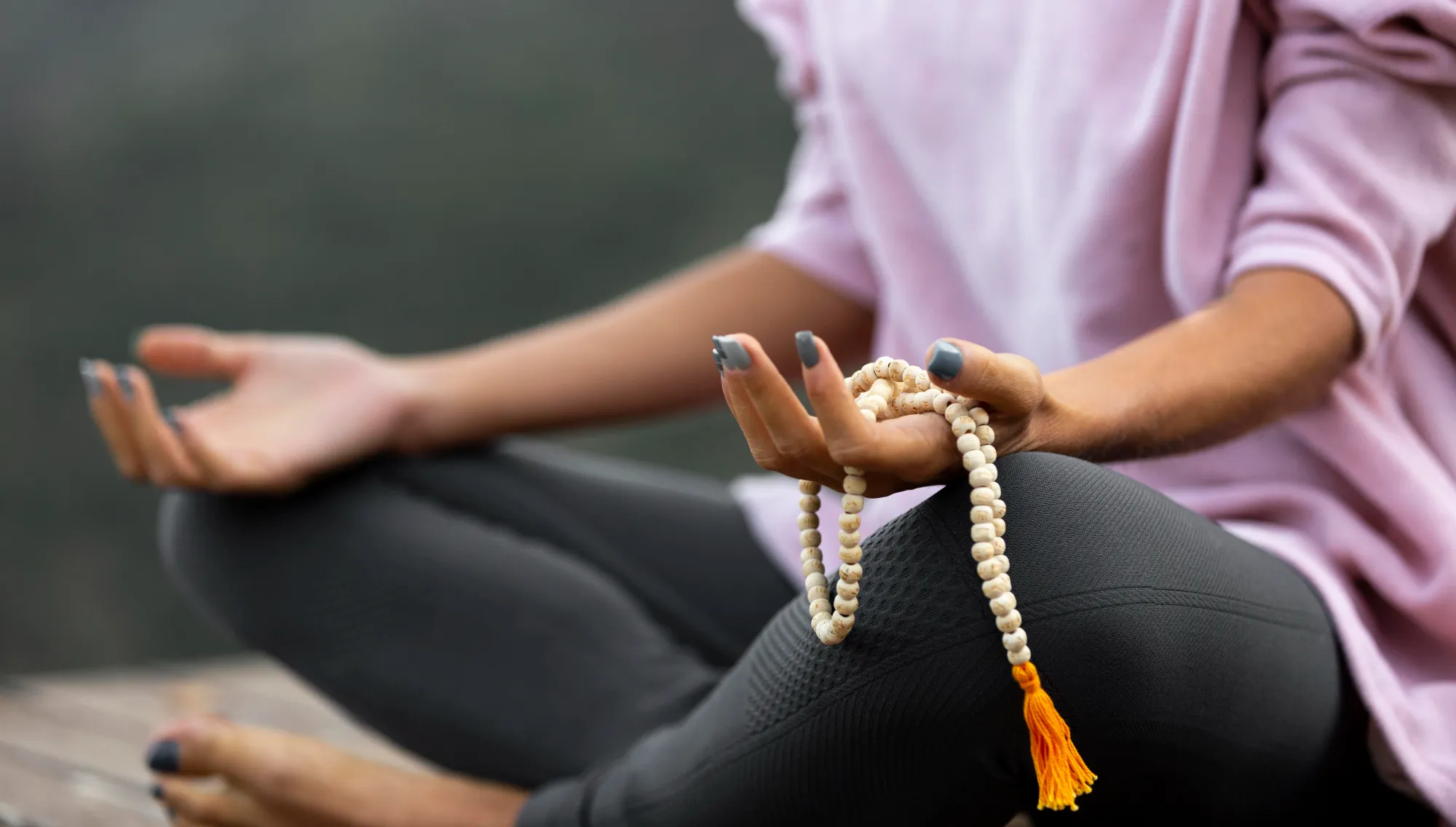 A woman chanting Mahakal Bhairav's mantra with rosary mala
