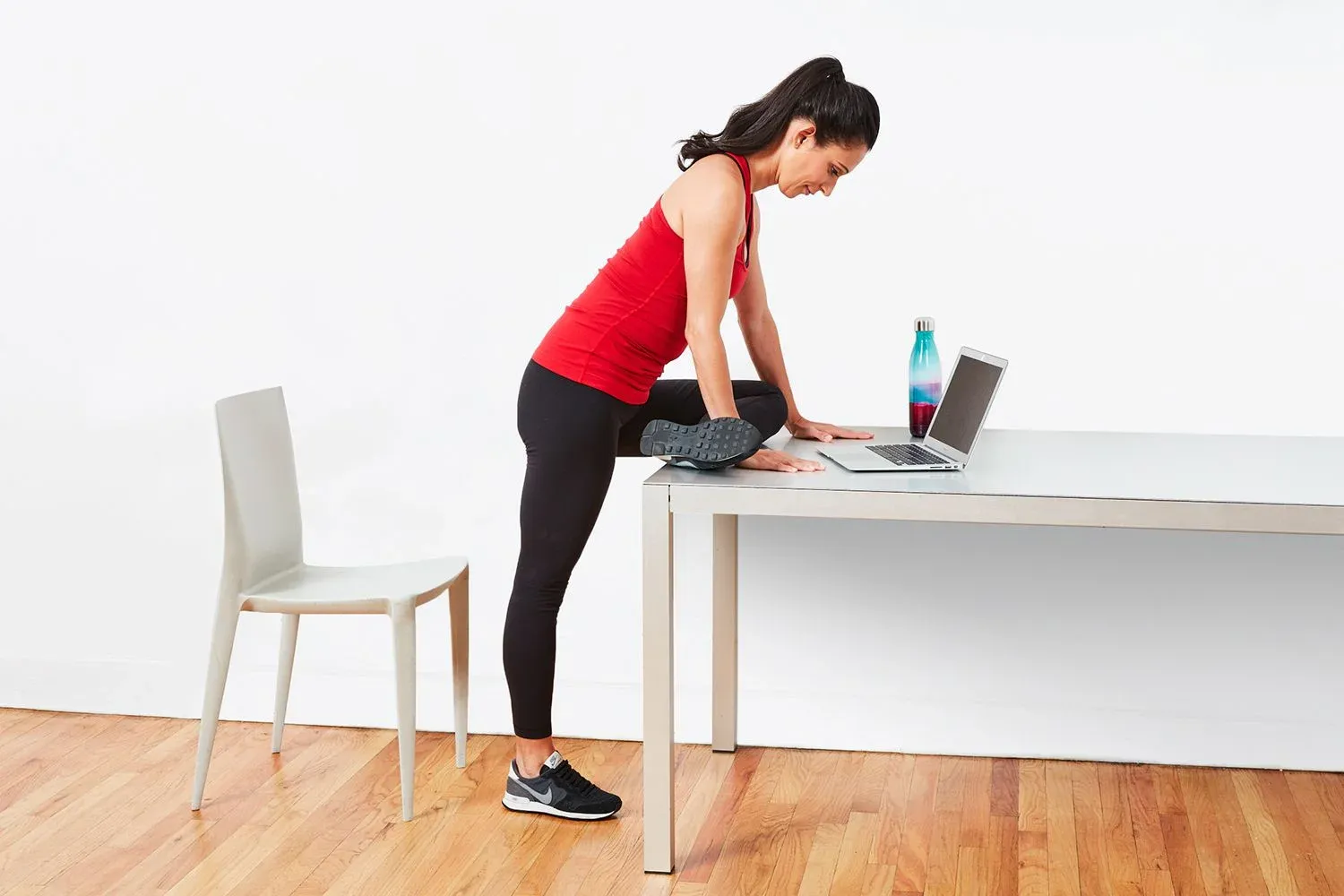 A woman doing sitting asana in the workplace