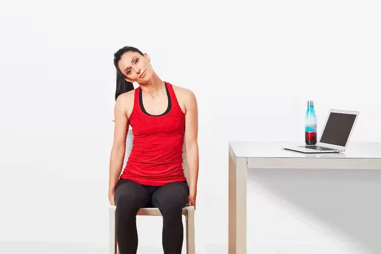 A woman doing neck rolls as a stretching yoga pose