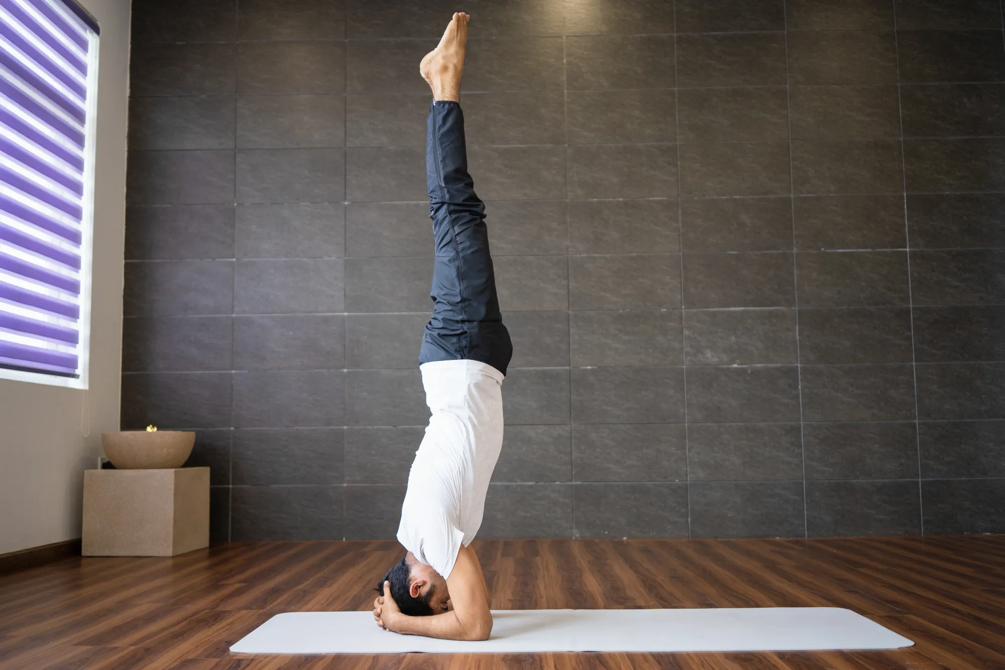 Headstand improves blood flow to the brain, thus aiding yoga for hair growth